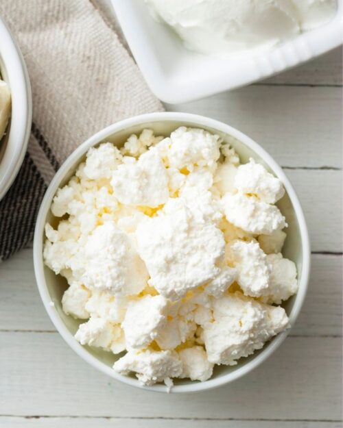 homemade ricotta cheese in a white bowl. 