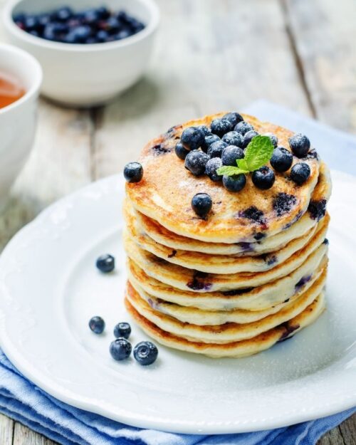 blueberry pancakes from sour milk on a white plate. 