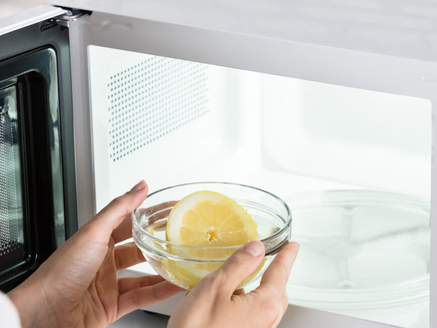 How To Clean Your Microwave with lemon in a bowl